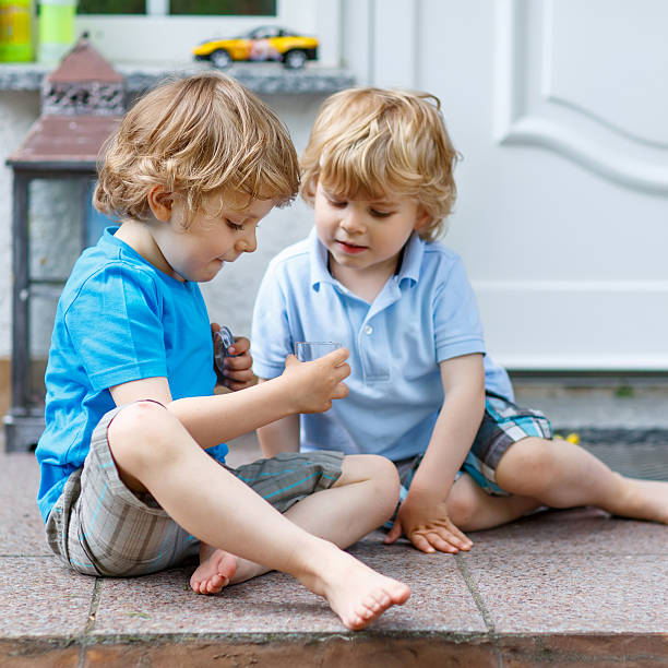 istock Two happy kid boys having fun together outdoors 482105642