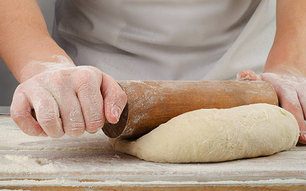istock Woman  preparing dough  on  wooden table. 482106212