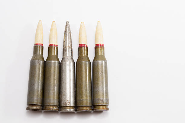 istock Kalashnikov riffle bullets in a row on a white background 482106308
