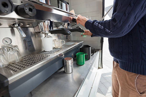 istock Midsection of man cleaning coffee machine at mobile shop 482109357