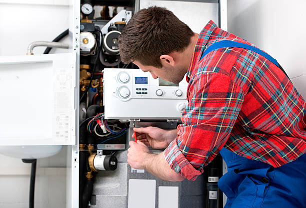 Technician servicing heating boiler Technician servicing the gas boiler for hot water and heating repairing stock pictures, royalty-free photos & images