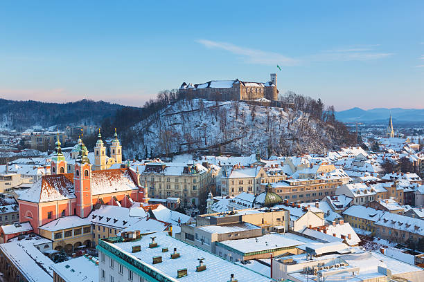 Panorama of Ljubljana in winter. Slovenia, Europe. Panoramic view of Ljubljana, capital of Slovenia. Roofs covered in snow in winter time. ljubljana castle stock pictures, royalty-free photos & images