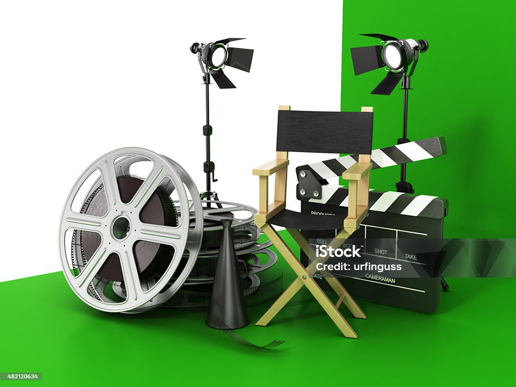 Video, movie, cinema concept. Video, movie, cinema concept. Light, film strip, reels, clapperboard and director chair on the green film background. 2015 Stock Photo