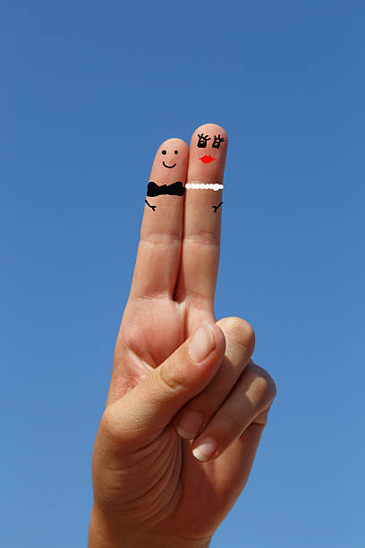 istock couple. two fingers painted with sky at background 482120762