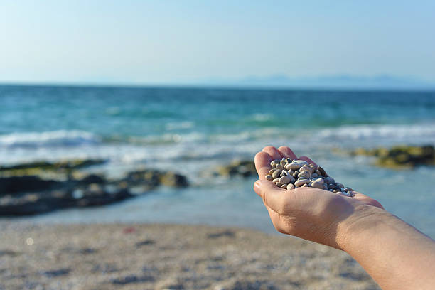 istock Hand full of small stones 482120926