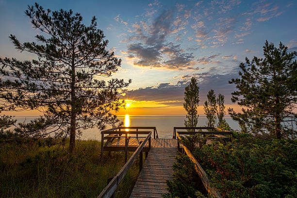 Lake Huron Boardwalk at Sunset Boardwalk Leading to a Lake Huron Sunset - Pinery Provincial Park, Ontario, Canada provincial park stock pictures, royalty-free photos & images