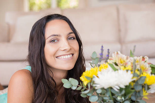 istock Pretty brunette smelling the flowers 482127112