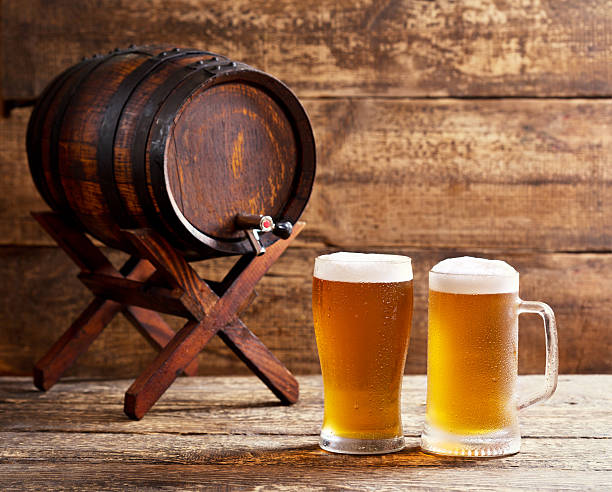 istock glasses of beer with barrel 482128462