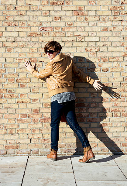 istock Joyful woman posing in front of brick wall 482132836