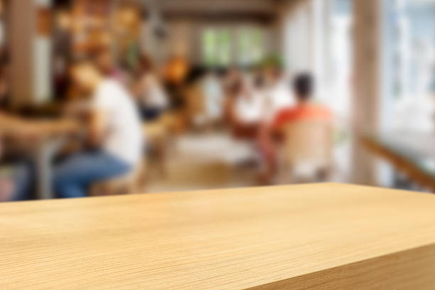 istock Empty wooden table and blurred people in cafe background 482135276