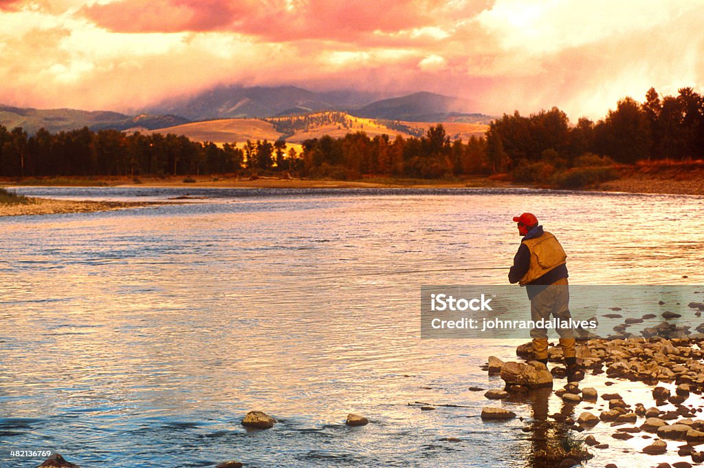 Damon Fishing on the Big Blackfoot River in Montana Damon flyfishing on the Blackfoot River near Missoula, Montana with a storm threatening in the background. Montana - Western USA Stock Photo