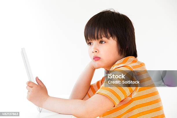 Boy Using A Digital Tablet Stock Photo - Download Image Now - 8-9 Years, Blue, Boys