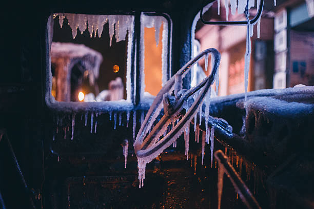 Burnt truck cab covered by ice.