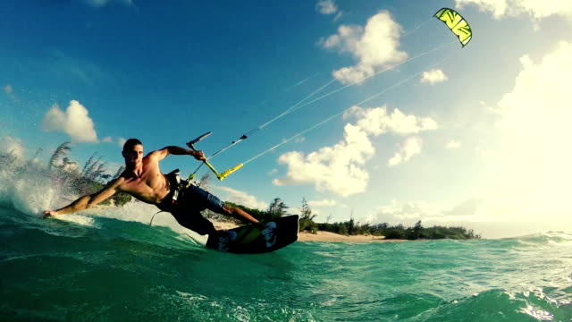 Young Man Kite Boarding in Ocean at Sunset.