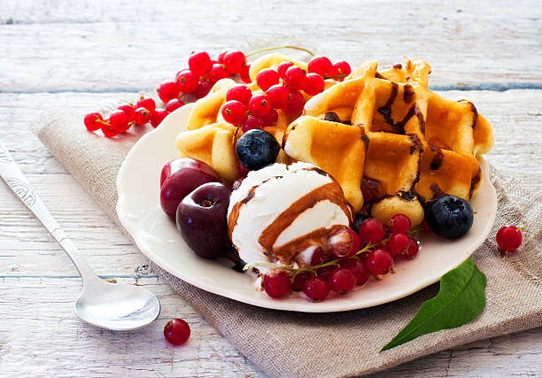 Belgium waffles with chocolate sauce, ice cream and rberries