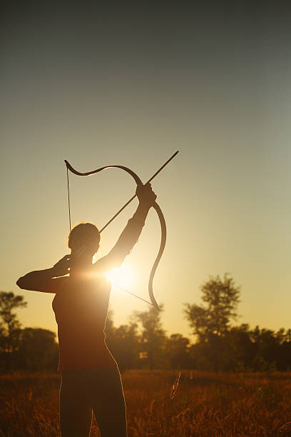 istock Female archer in the field at sunset 482142218