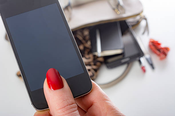 istock Elderly woman holds phone with clipping path (display) 482146406