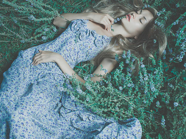 istock Beautiful lady lying amond flowers 482149219