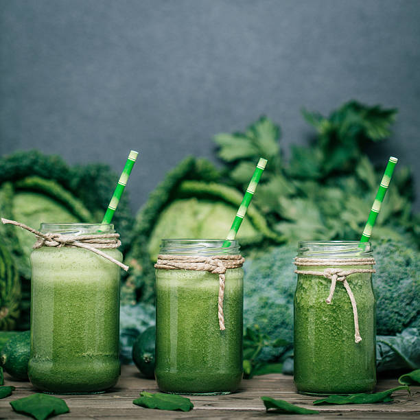 istock Blended green smoothie with ingredients on wooden table 482150604