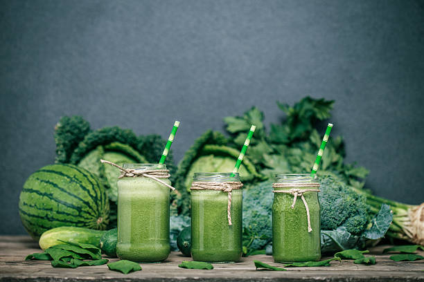 istock Blended green smoothie with ingredients on wooden table 482151020