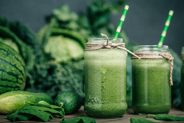 istock Blended green smoothie with ingredients on wooden table 482151810