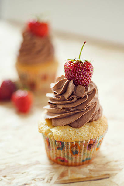 istock Vanilla cupcakes with chocolate butter cream icing and fresh strawberries 482152006