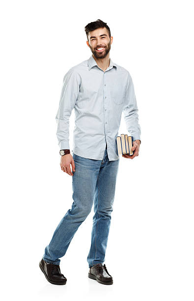 istock Young bearded smiling man with books in hand on white 482152208
