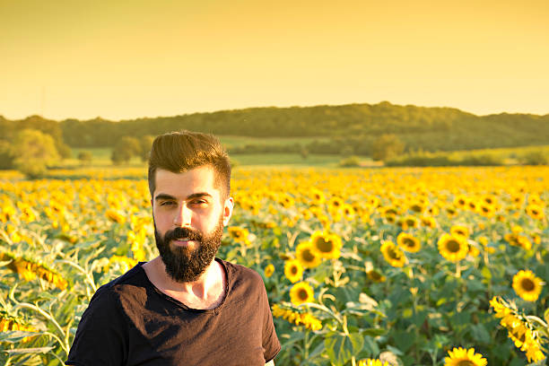 istock Young Man in Sunflower Field 482156416