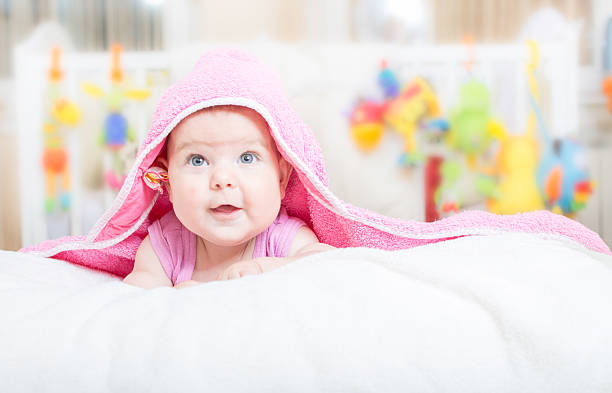istock Little baby lying on the bed and smiling 482159750