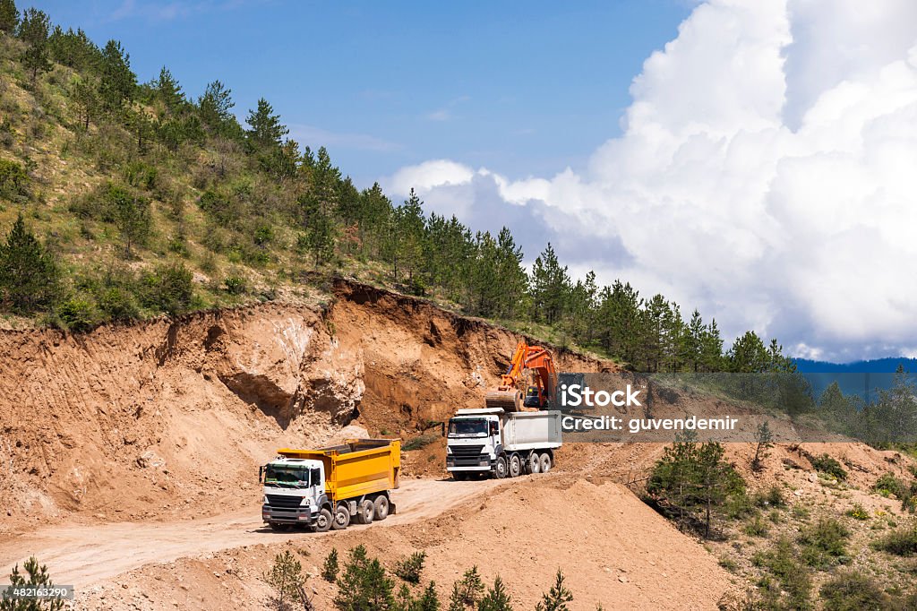 Excavator loading dumper truck 2015 Stock Photo