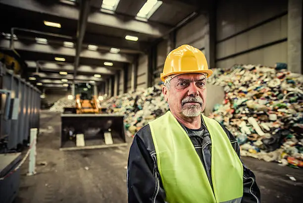 Photo of Portrait of the worker at the garbage dump