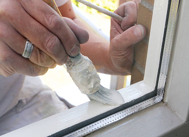 istock Looking through a window. Painter painting a window for home improvement. 482173408