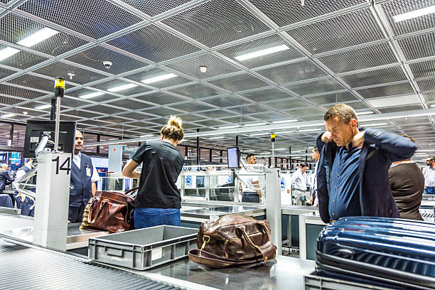 people at security check at Frankfurt international airport Frankfurt, Germany - June 18, 2015: people at security check at Frankfurt international airport in Frankfurt, Germany. In 2012, Frankfurt handled 57.5 million passengers. photography hessen germany central europe stock pictures, royalty-free photos & images