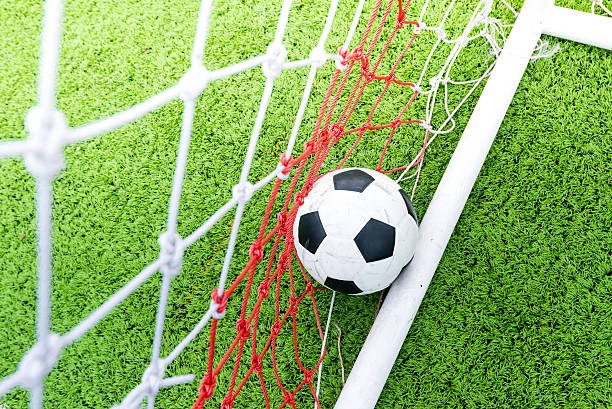 istock Ball in soccer goal net 482180288