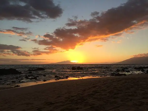 Sun setting over the ocean in Maui.