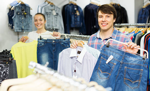 istock Couple choosing clothes in the mall 482180830