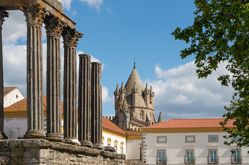 The Temple of Diana is a Roman temple located right in the heart of the historic city of Évora, Portugal. In the distance one can see the dome of the cathedral of Evora.