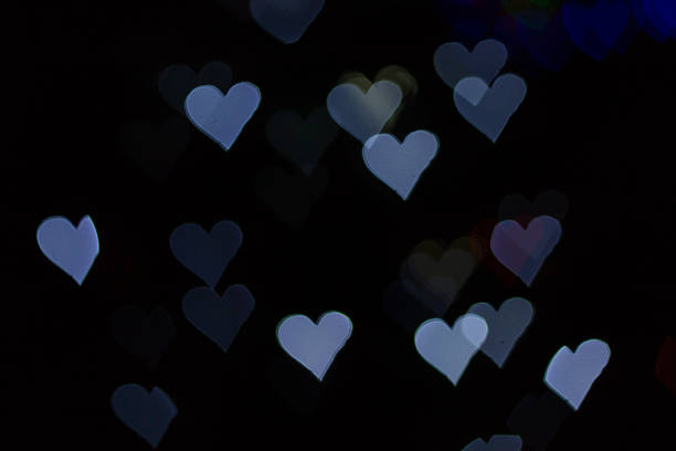 istock Color Bokeh on a dark background with hearts 482184766