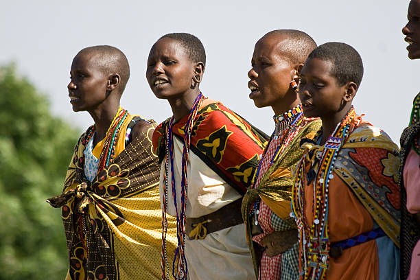Masai Mara, Kenya - July 12, 2010: Maasai women sing and dance a traditional performance in their village.