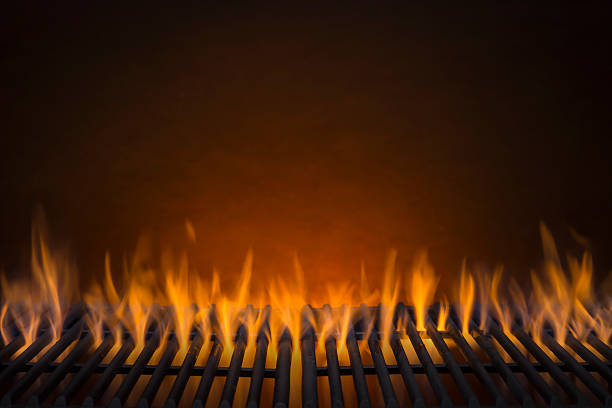 Flaming Hot Barbecue Grill Flaming Hot Barbecue Grill and a Glowing Amber Background amber black photography stock pictures, royalty-free photos & images