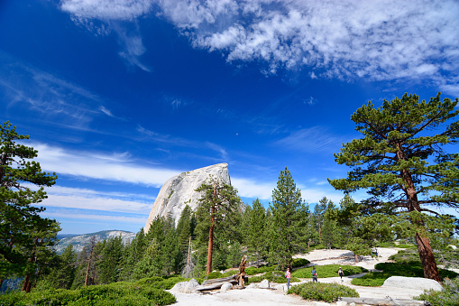 Yosemite, USA - July 7, 2015: Yosemite National Park, Hikers hiking around and climbing half dome on a sunny day