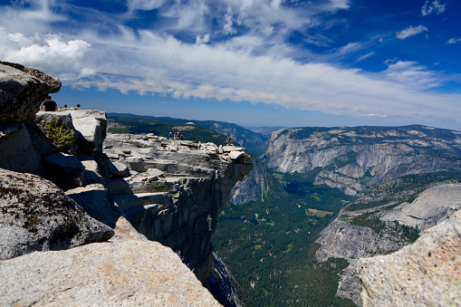 Yosemite, USA - July 7, 2015: Yosemite National Park, Hikers hiking around and climbing half dome on a sunny day