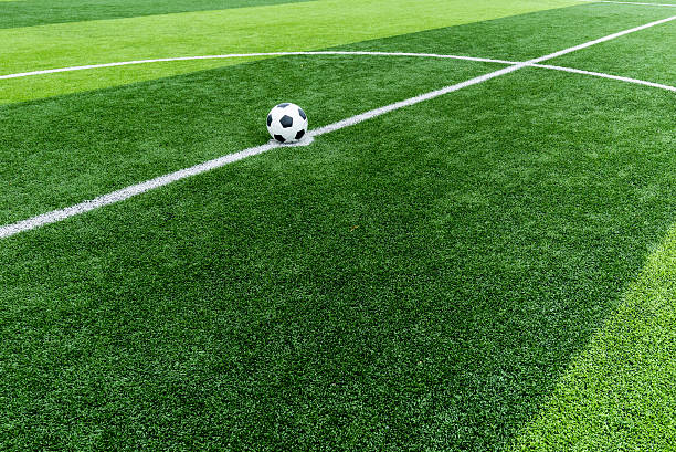 istock soccer field grass with ball at kick off point. 482190458