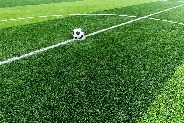 soccer field grass with ball at kick off point. stock photo