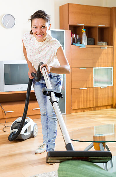 istock Woman with vacuum cleaner 482190484