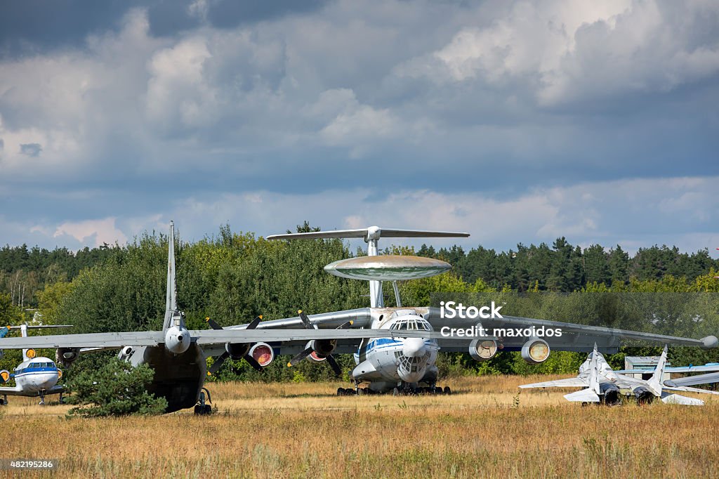 Old aircrafts on the abandoned aerodrome Old Russian aircrafts at the abandoned aerodrome in summertime. Cemetery of large and small aircraft near the runway 2015 Stock Photo