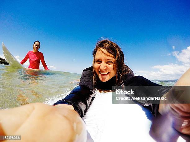 Surfer Girls Making A Selfie Stock Photo - Download Image Now - Surfing, Selfie, Breaking Wave