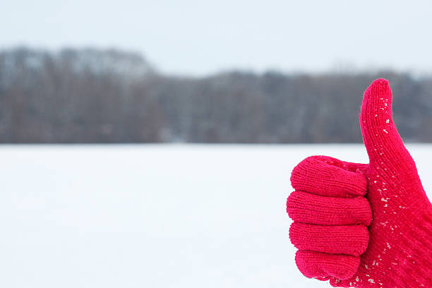 istock hand in red woolen glove with thumb up on winter 482198554