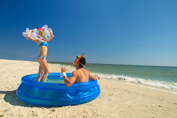 istock Newly-married couple enjoying on the beach 482208529