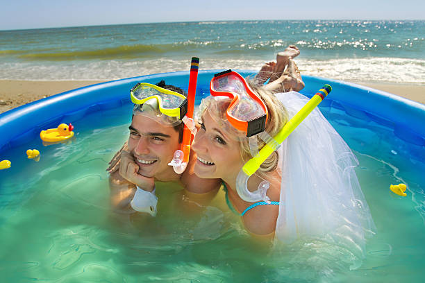 istock Newly-married couple enjoying on the beach 482208623